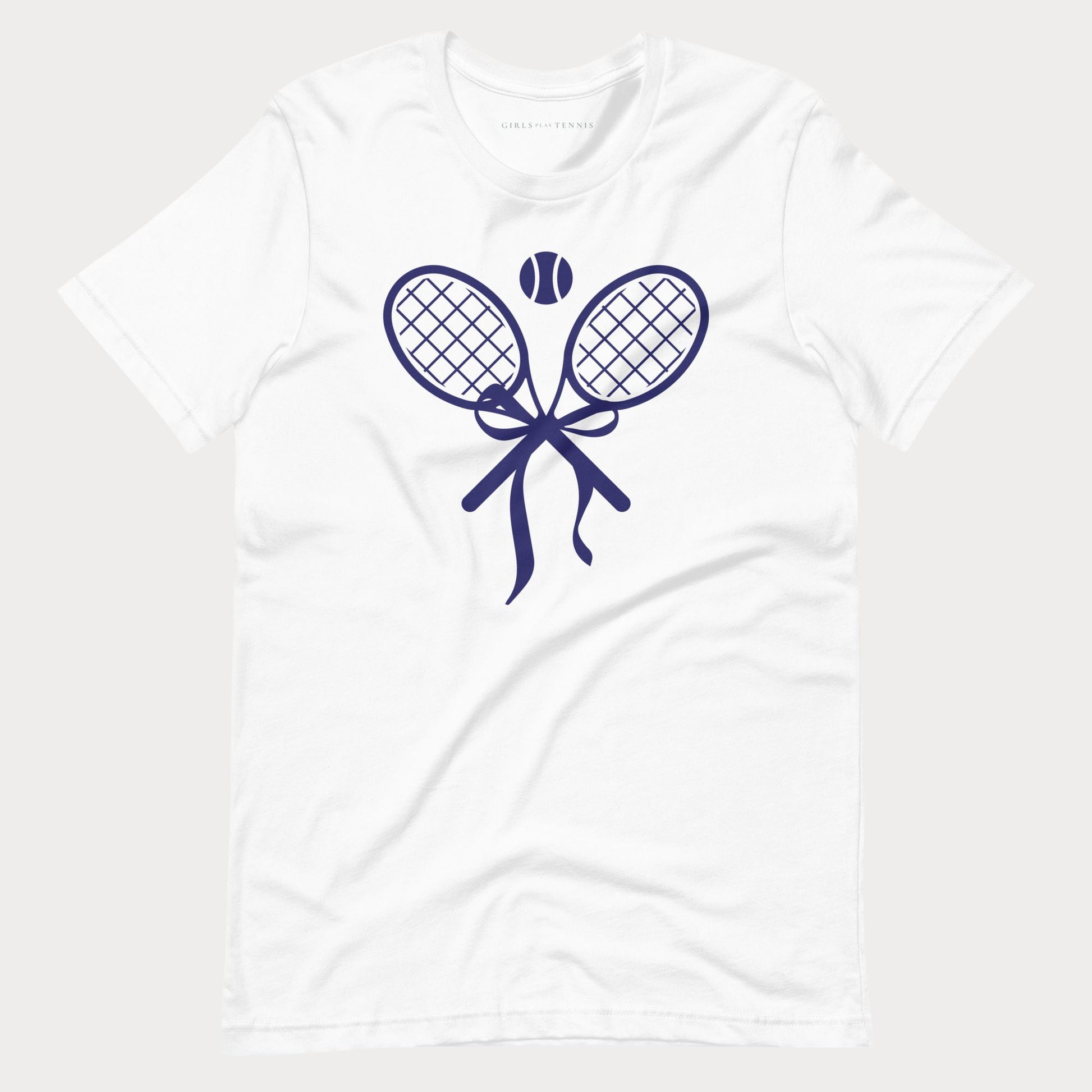 A white short-sleeve crewneck tennis t-shirt featuring a navy blue graphic of two tennis rackets tied in a bow with a tennis ball above them, displayed on a light gray background.