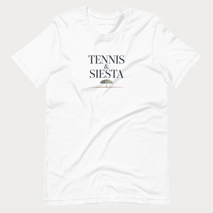 A white short-sleeve crewneck women's lifestyle t-shirt with 'TENNIS & SIESTA' printed in black serif letters on the chest, with a small umbrella graphic underneath, shown against a light gray background.