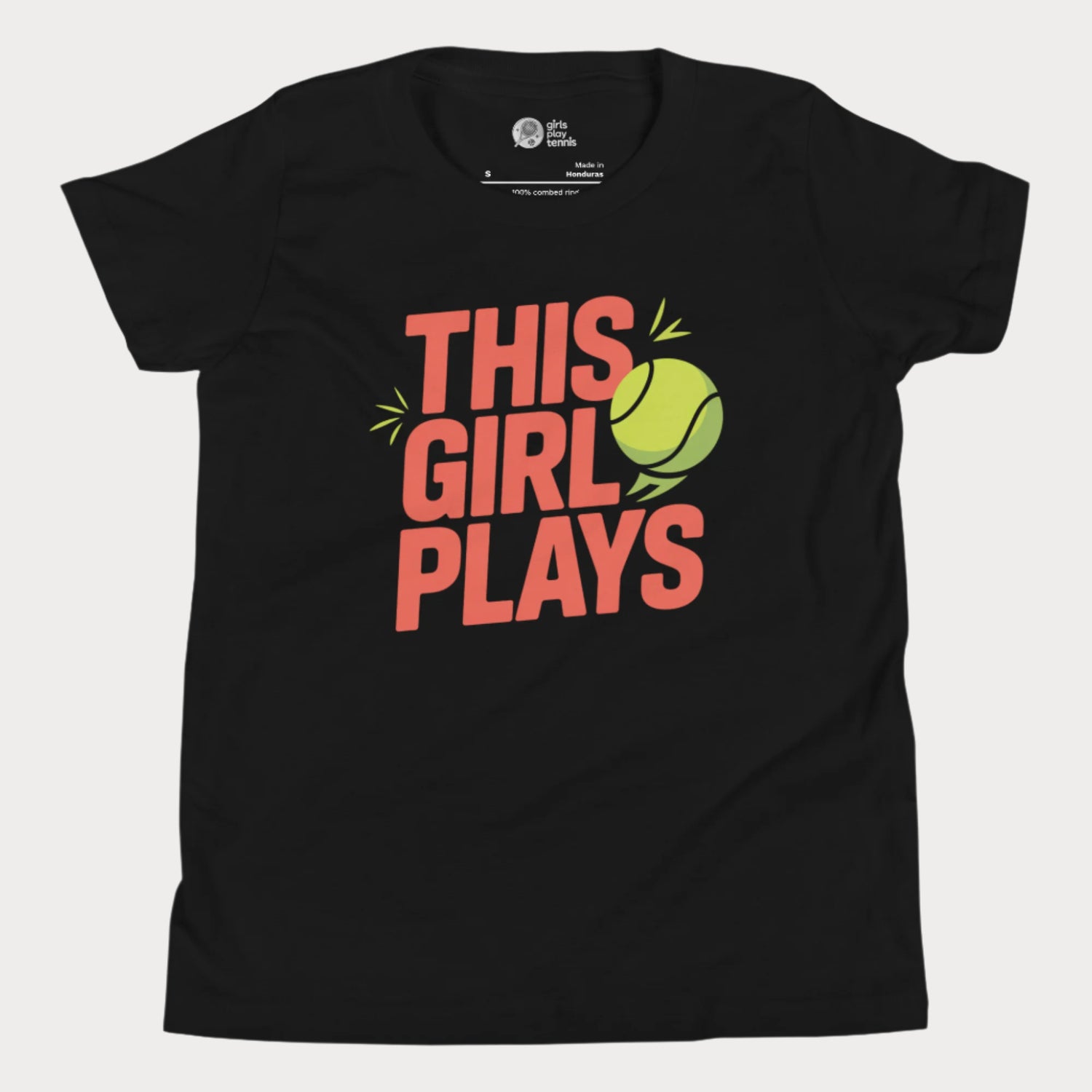 Black girls' tennis t-shirt with bold “This Girl Plays” slogan and tennis ball graphic