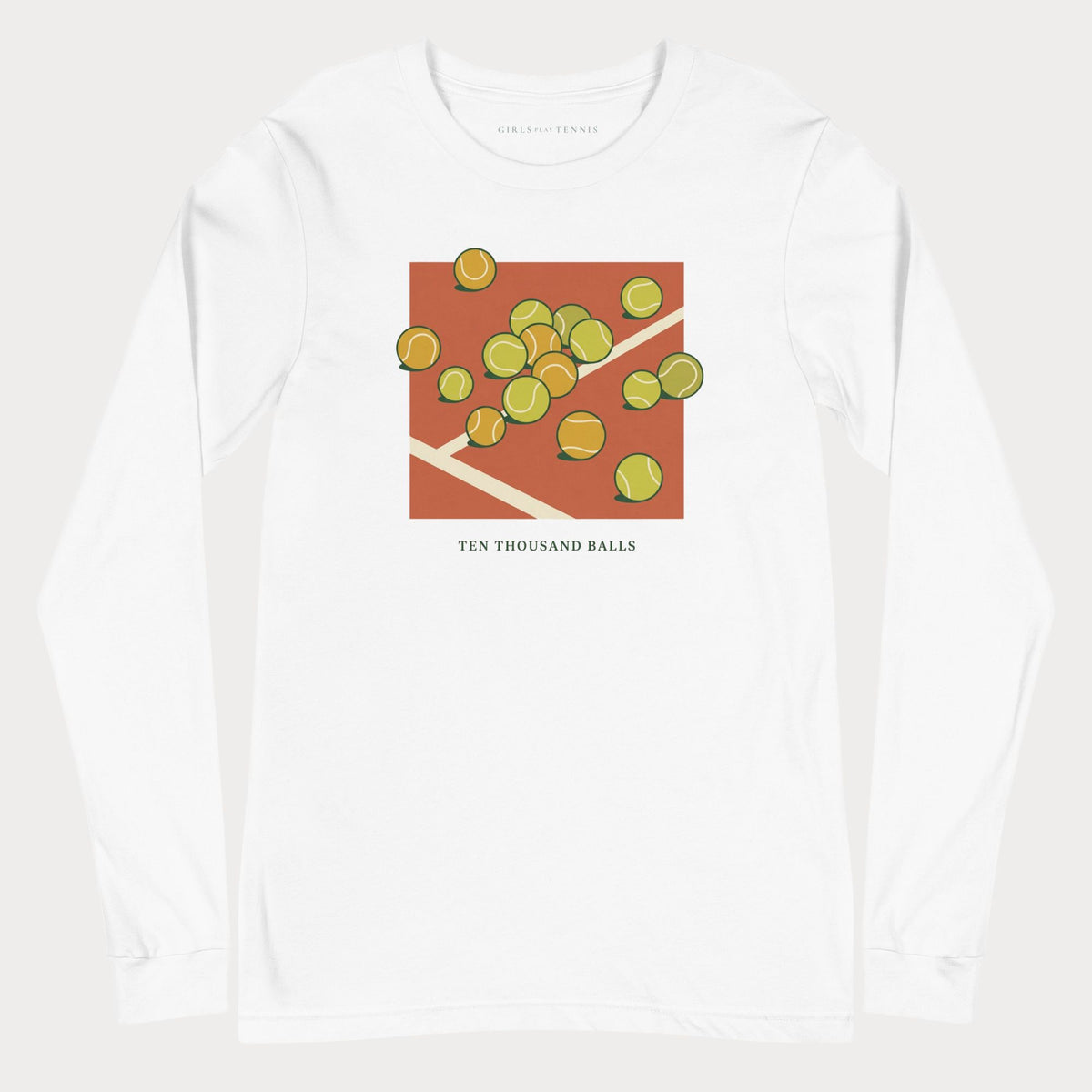 White Ten Thousand Balls women's tennis long-sleeve T-shirt with a clay-red square covered in scattered tennis balls above the words Ten Thousand Balls
