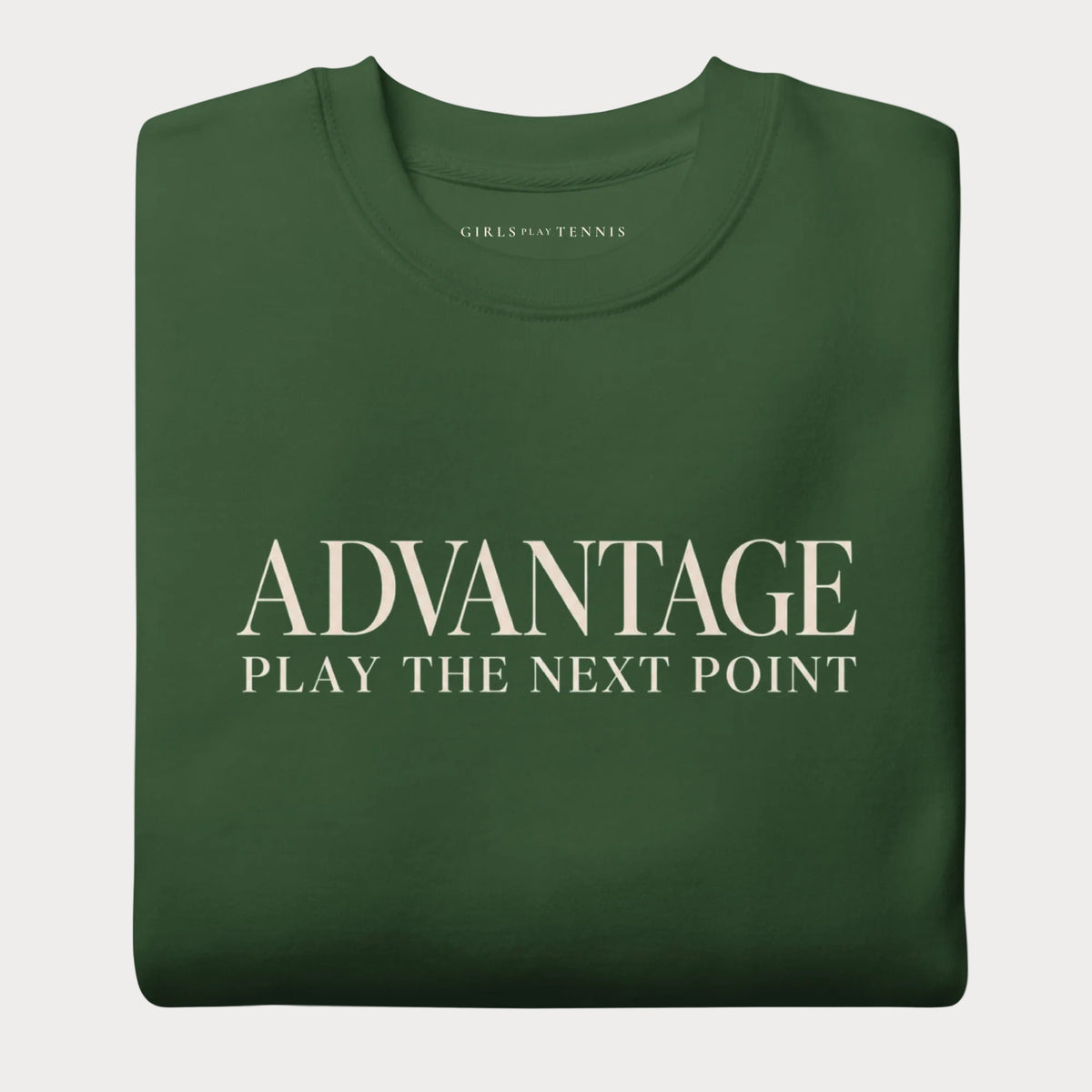 Folded forest green Advantage women's tennis crewneck sweatshirt with cream lettering reading Advantage above Play the Next Point