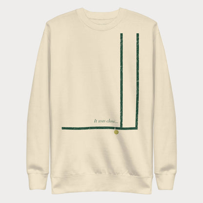 Bone It Was Close... women's tennis crewneck sweatshirt with worn forest green court-corner lines, a tennis ball just past the line and the script caption It was close...