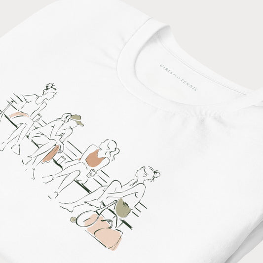 Close-up of a white tennis T-shirt with a line illustration of tennis players chatting on a bench, with rackets, tennis balls and a duffel bag