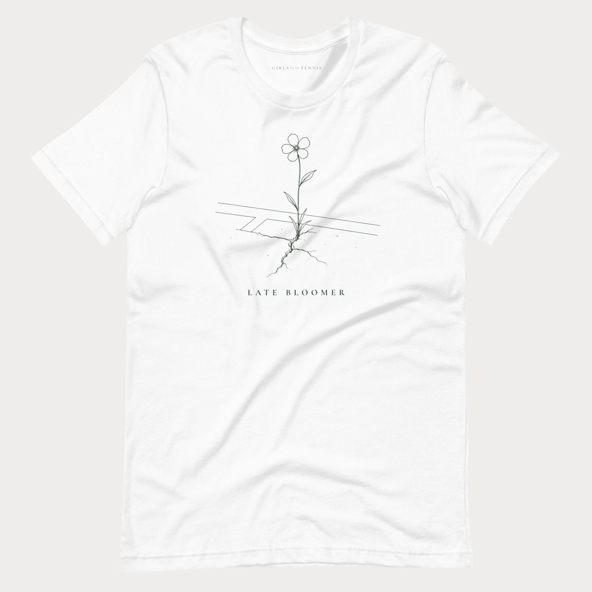 White Late Bloomer women's tennis T-shirt with a line drawing of a flower growing through a crack in a court line