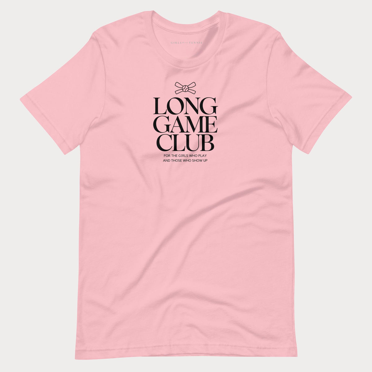 Pink Long Game Club women's tennis T-shirt with stacked lettering and a small bow