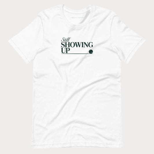 White Still Showing Up women's tennis T-shirt with lettering and a progress line ending in a tennis ball