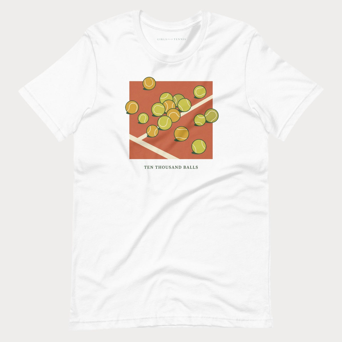 White Ten Thousand Balls women's tennis T-shirt with a clay-red square covered in scattered tennis balls