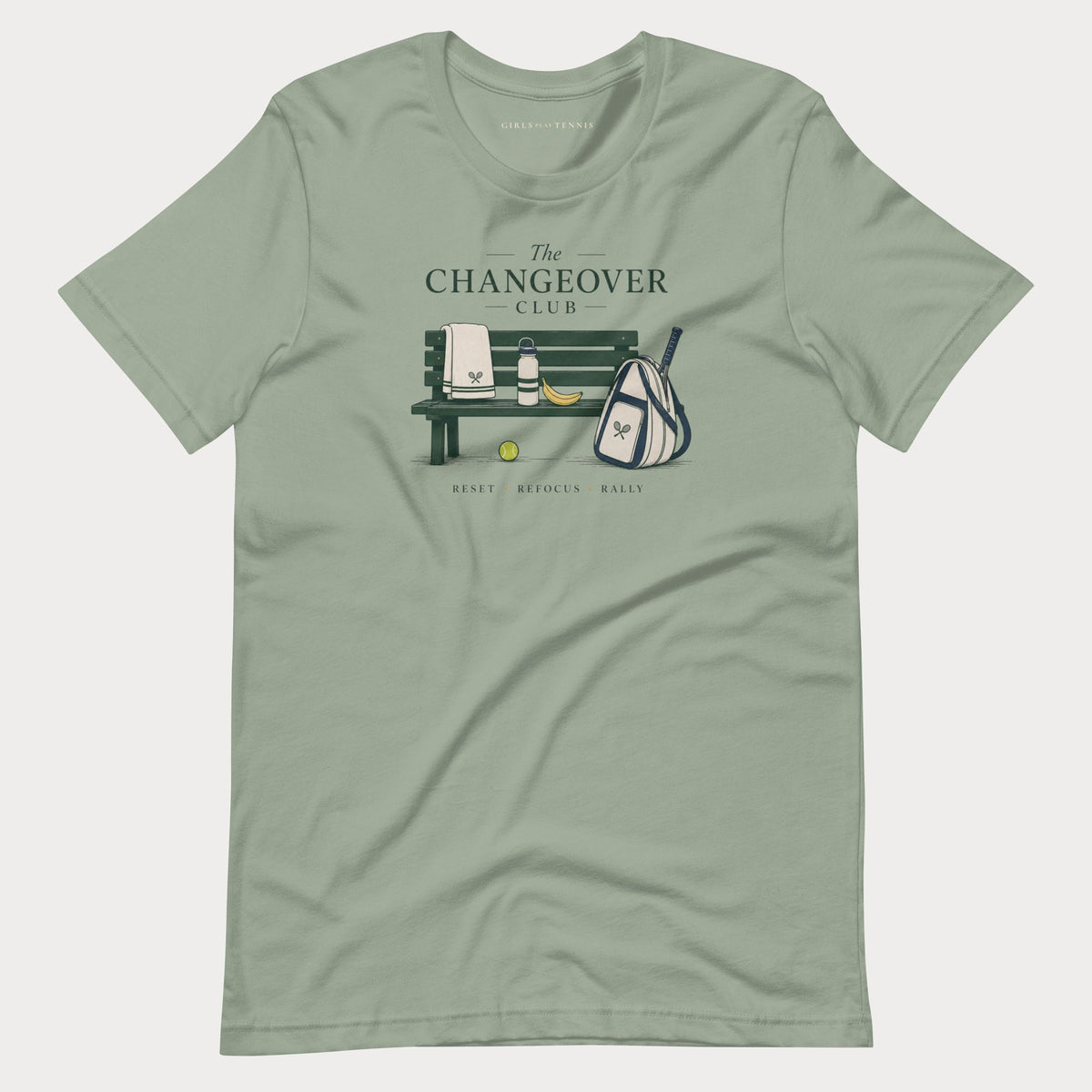 Sage green The Changeover Club women's tennis T-shirt with a courtside bench, towel, racket bag and banana illustration