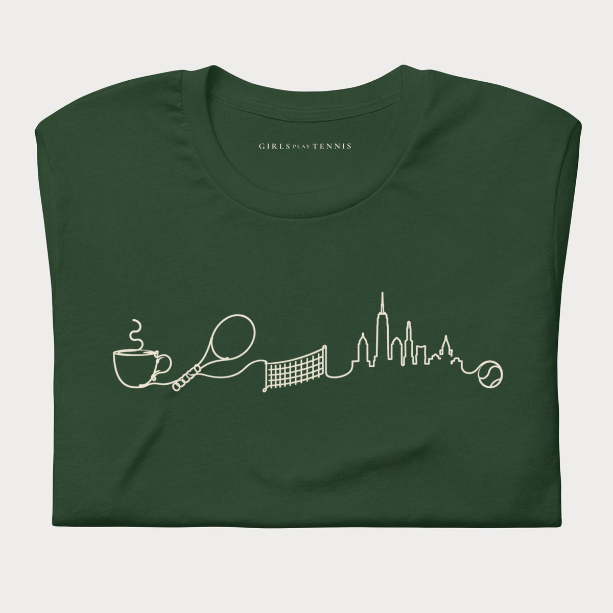 Folded forest green The Long Rally women's tennis T-shirt with a line drawing of a coffee cup, racket, net and city skyline